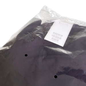 Close up of Better Packaging POLLAST!C poly garment bag with ventilation holes and shirt with barcode tag